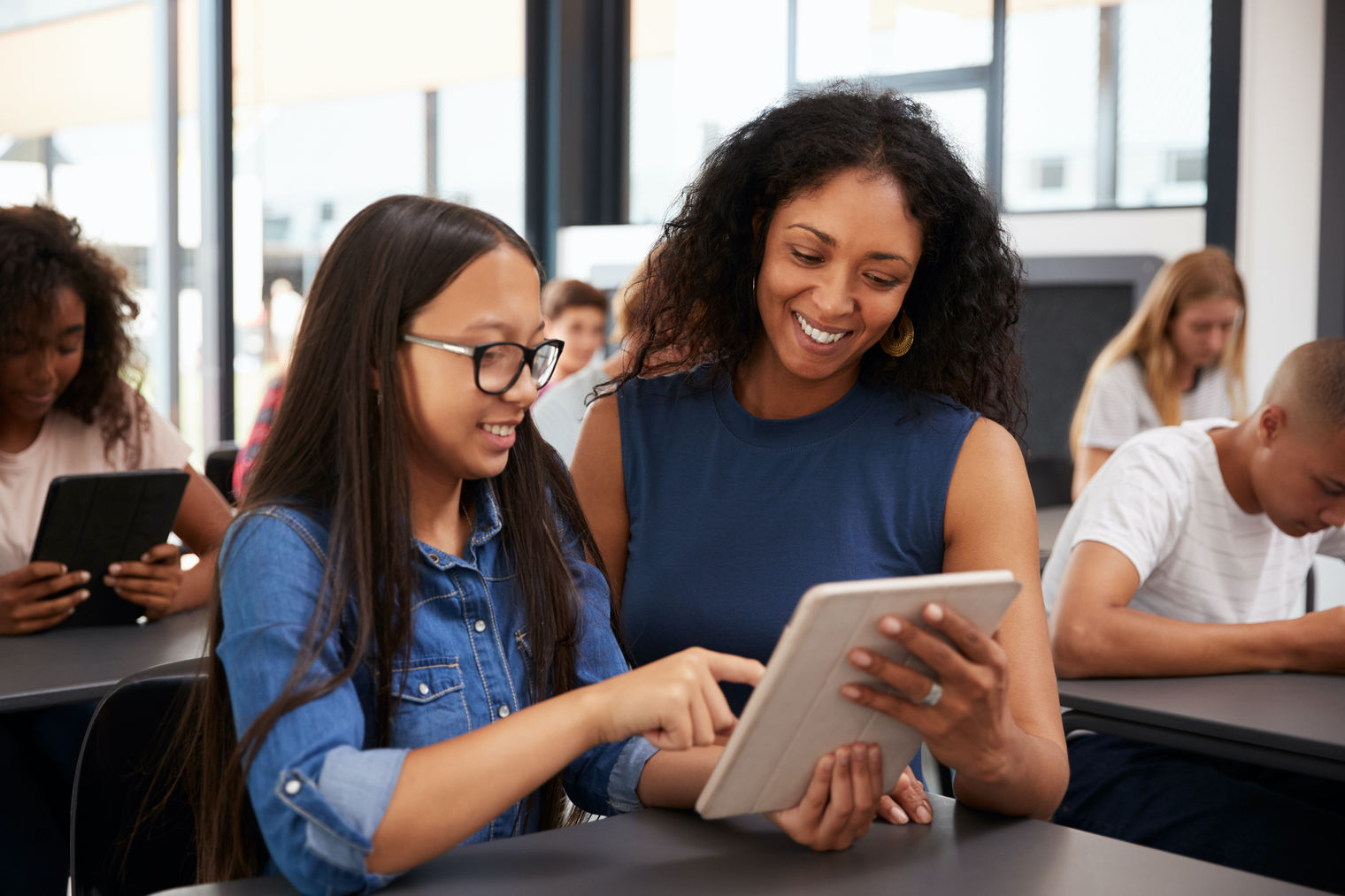 student and teacher smiling