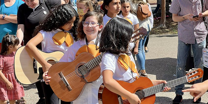line of students with guitars smiling