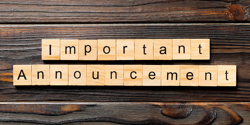board with letters reading important announcement