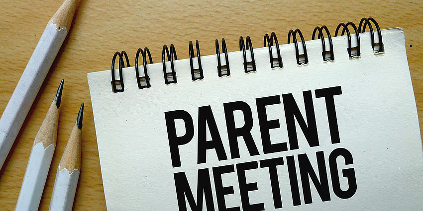 notebook that says: Parent Meeting
