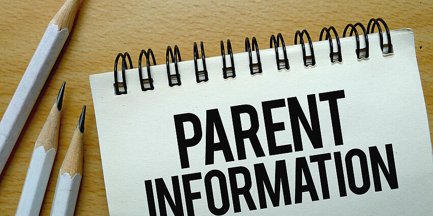 spilar notebook with the words parent information and some sharppened pencils on the side