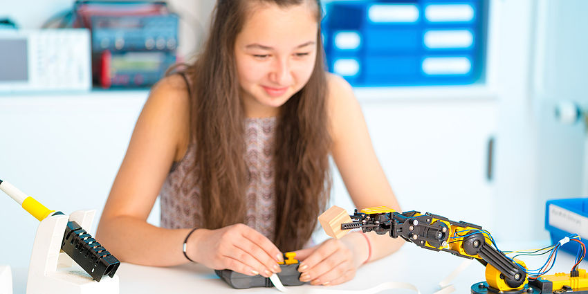 girl works on robotics project