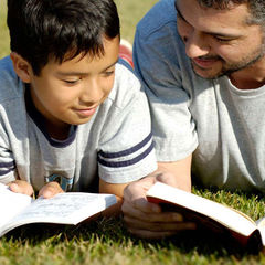 father reading with son