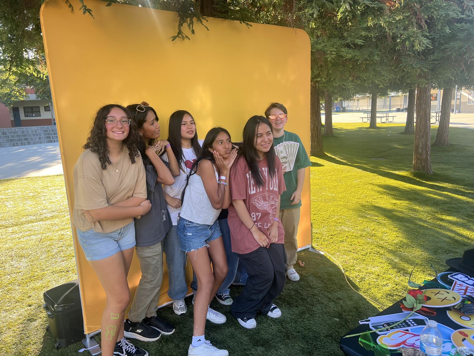 Students pose for pictures at event photo booth