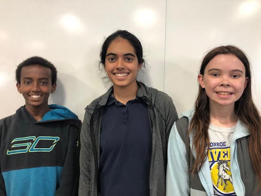 three spelling bee winners smiling
