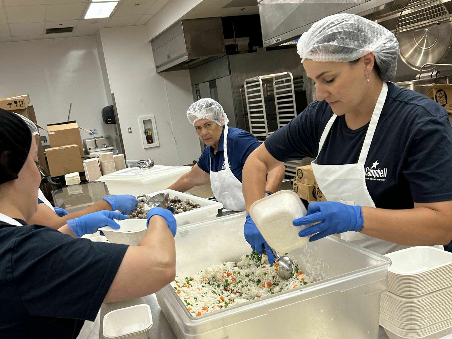 Ladies prepping lunches in the central kitchen.